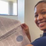 Malia Jenkins holding her first published article